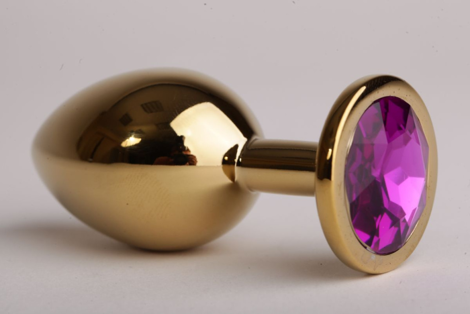 Золотистая анальная пробка с филетовым кристаллом - 8,2 см. купить в секс шопе