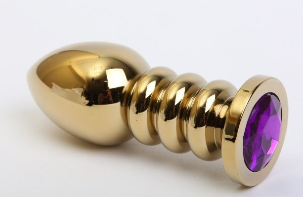 Золотистая фигурная анальная пробка с фиолетовым стразом - 10,3 см. купить в секс шопе