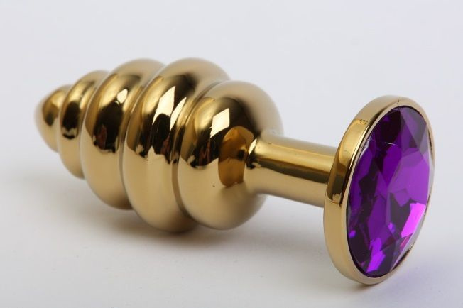 Золотистая рифлёная пробка с фиолетовым стразом - 8,2 см. купить в секс шопе