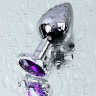 Серебристая коническая анальная пробка с фиолетовым кристаллом - 8 см. купить в секс шопе