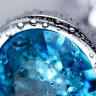 Серебристая конусовидная анальная пробка с голубым кристаллом - 8 см.  купить в секс шопе