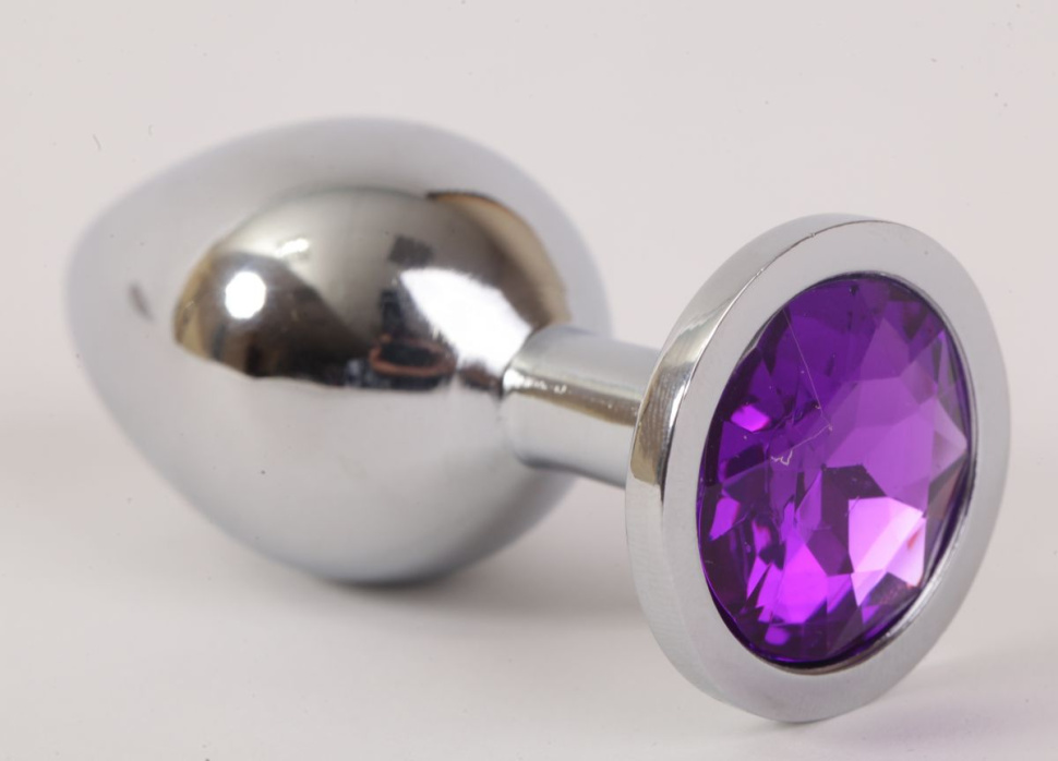 Серебристая анальная пробка с фиолетовым стразом - 8,2 см. купить в секс шопе