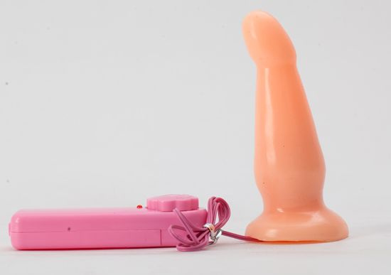 Анальная чуть изогнутая телесная пробка с вибрацией - 12 см. купить в секс шопе