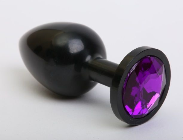 Чёрная анальная пробка с фиолетовым стразом - 7,6 см. купить в секс шопе