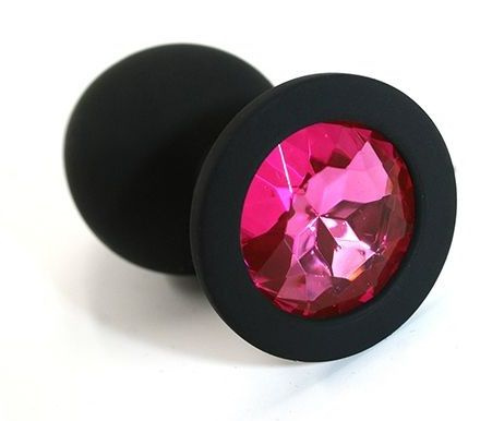 Чёрная силиконовая анальная пробка с ярко-розовым кристаллом - 7 см. купить в секс шопе