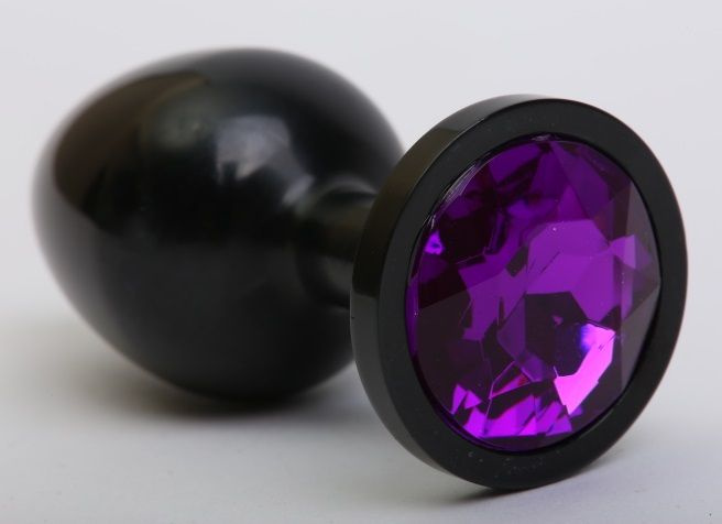 Чёрная анальная пробка с фиолетовым стразом - 8,2 см. купить в секс шопе