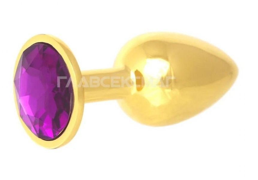 Золотистая анальная пробка с фиолетовым кристаллом - 7 см. купить в секс шопе