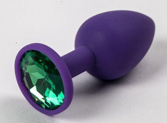 Фиолетовая силиконовая анальная пробка с зеленым стразом - 7,1 см. купить в секс шопе